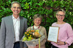 Stefan Hell (Vorstand der Volksbank), Dorothea Kleinknecht mit Blumenstrauß in der Hand sowie Beraterin Plöger.