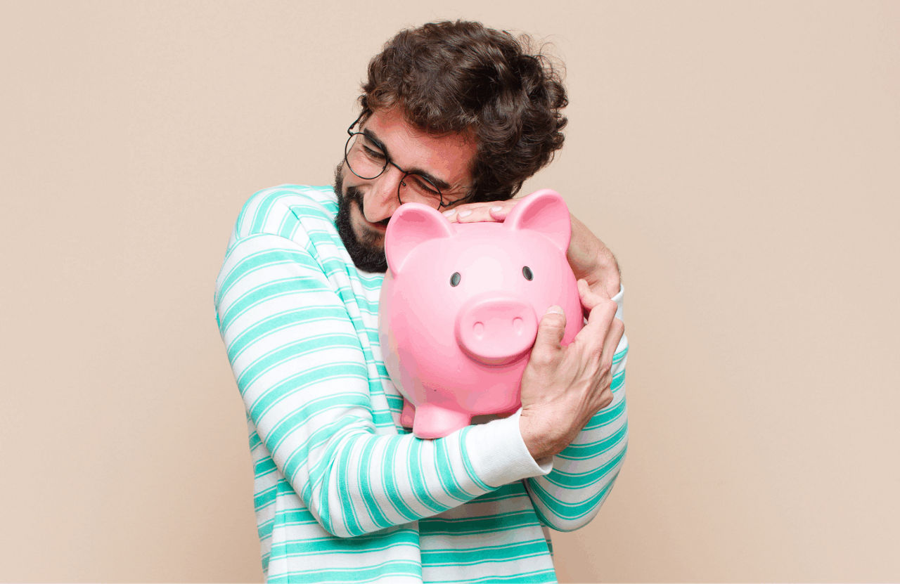 Mann im gestreiften Shirt umarmt rosa Sparschwein