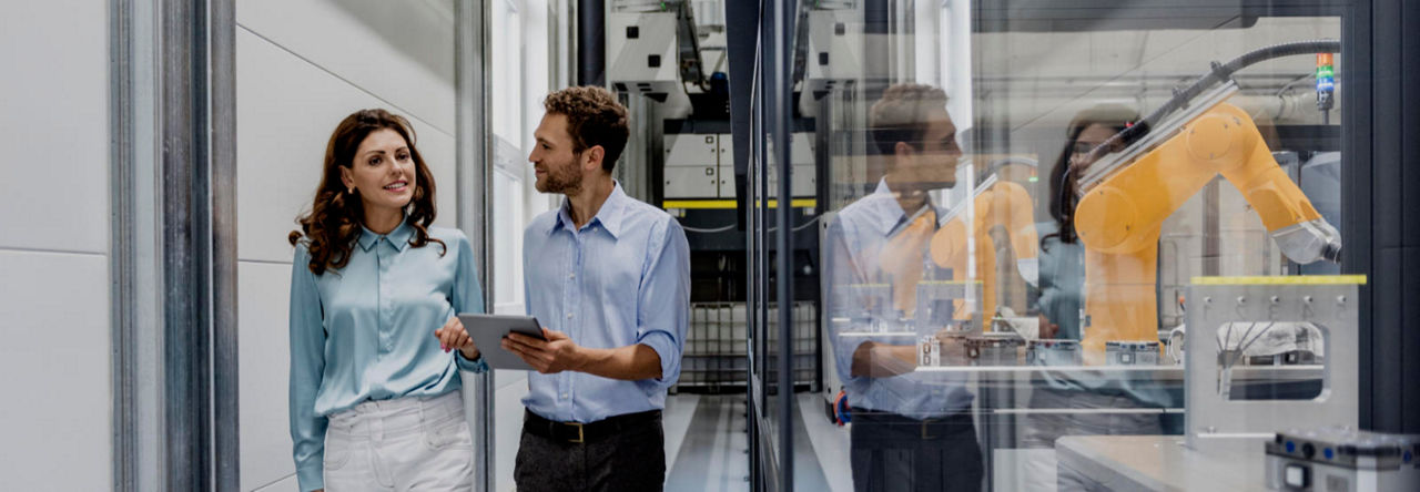 Businessman and woman having a meeting in high tech company
