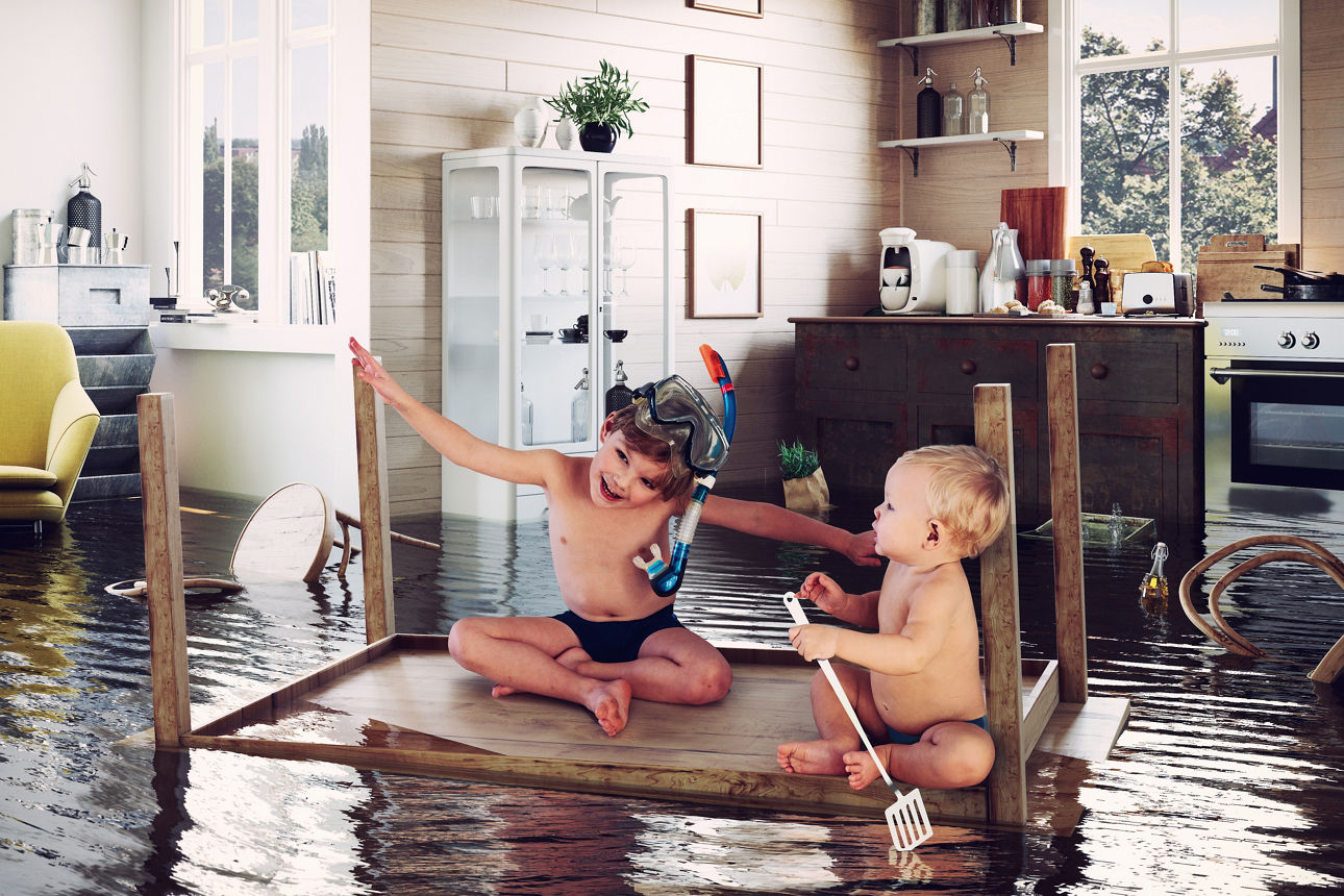 kids pday on the table while flooding in the kitchen. Photo and media photocombination