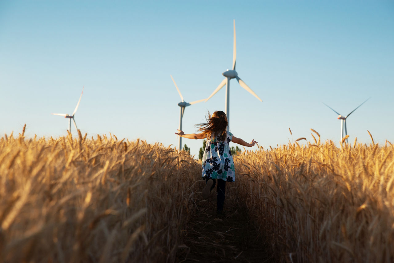 A little girl running through a wheat field