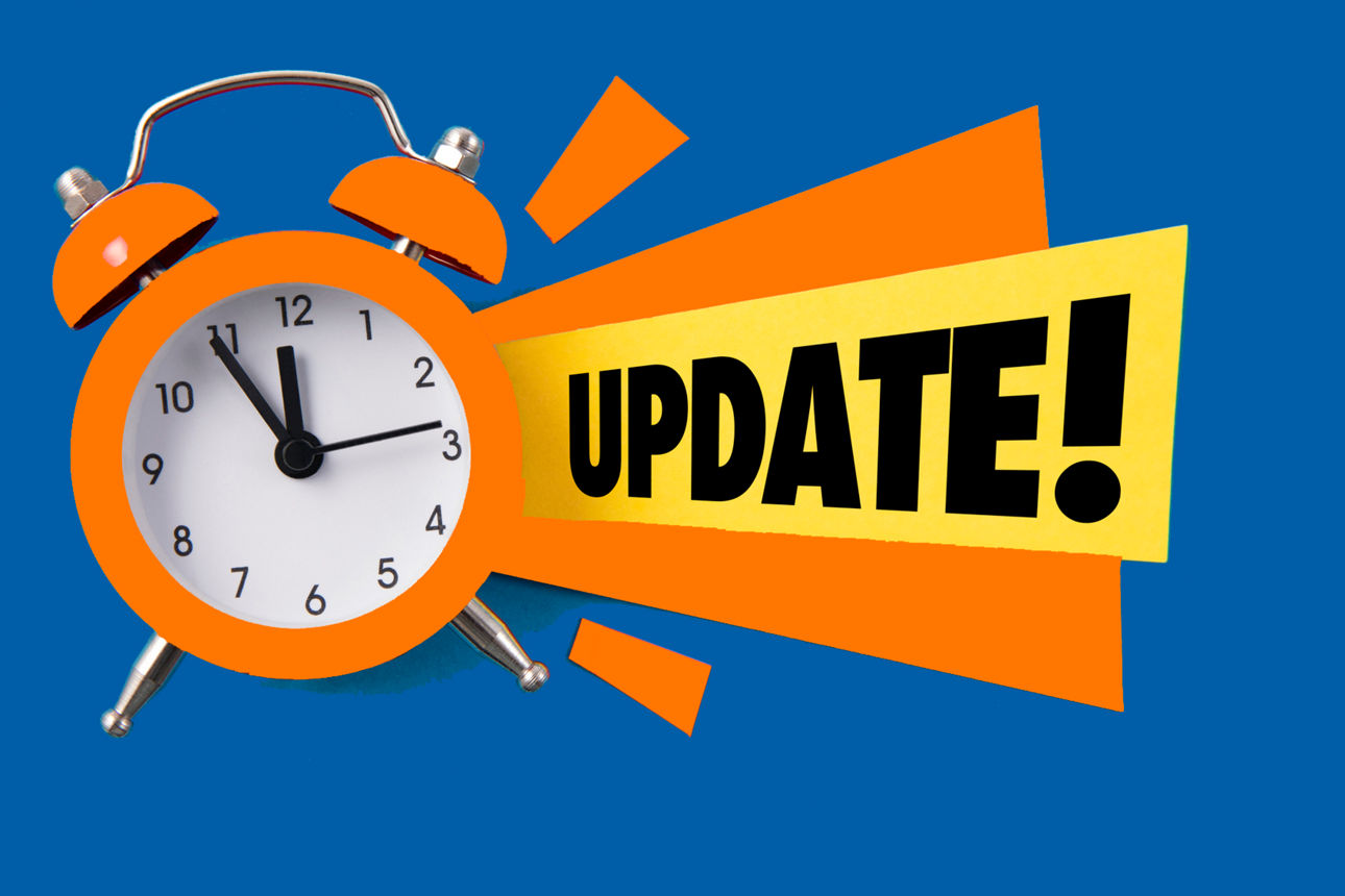 Orange alarm clock with colored papers and update text on blue background