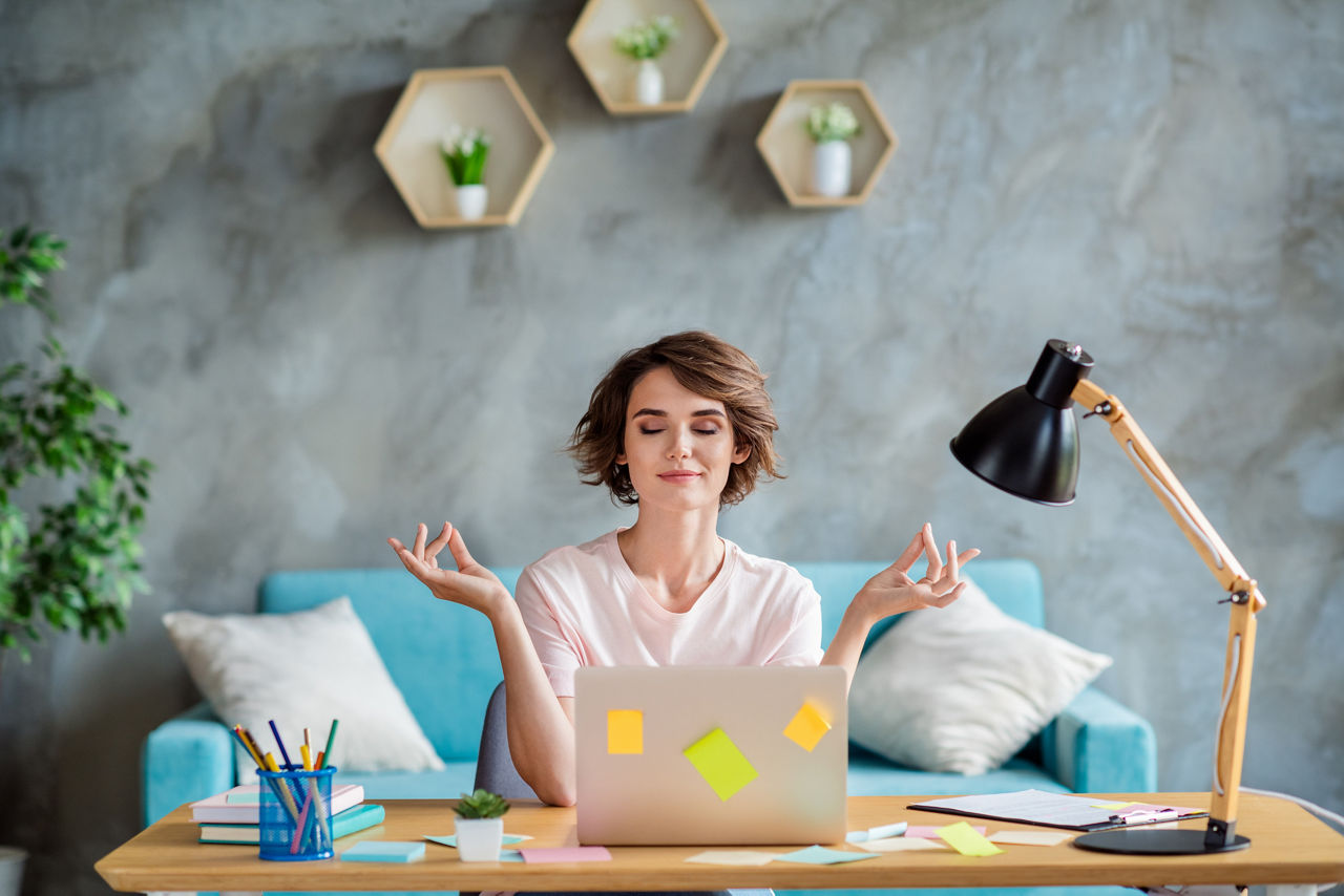 Photo of young attractive woman bob brown hair wearing pink t shirt sitting chair desk balance meditation while working laptop indoors.