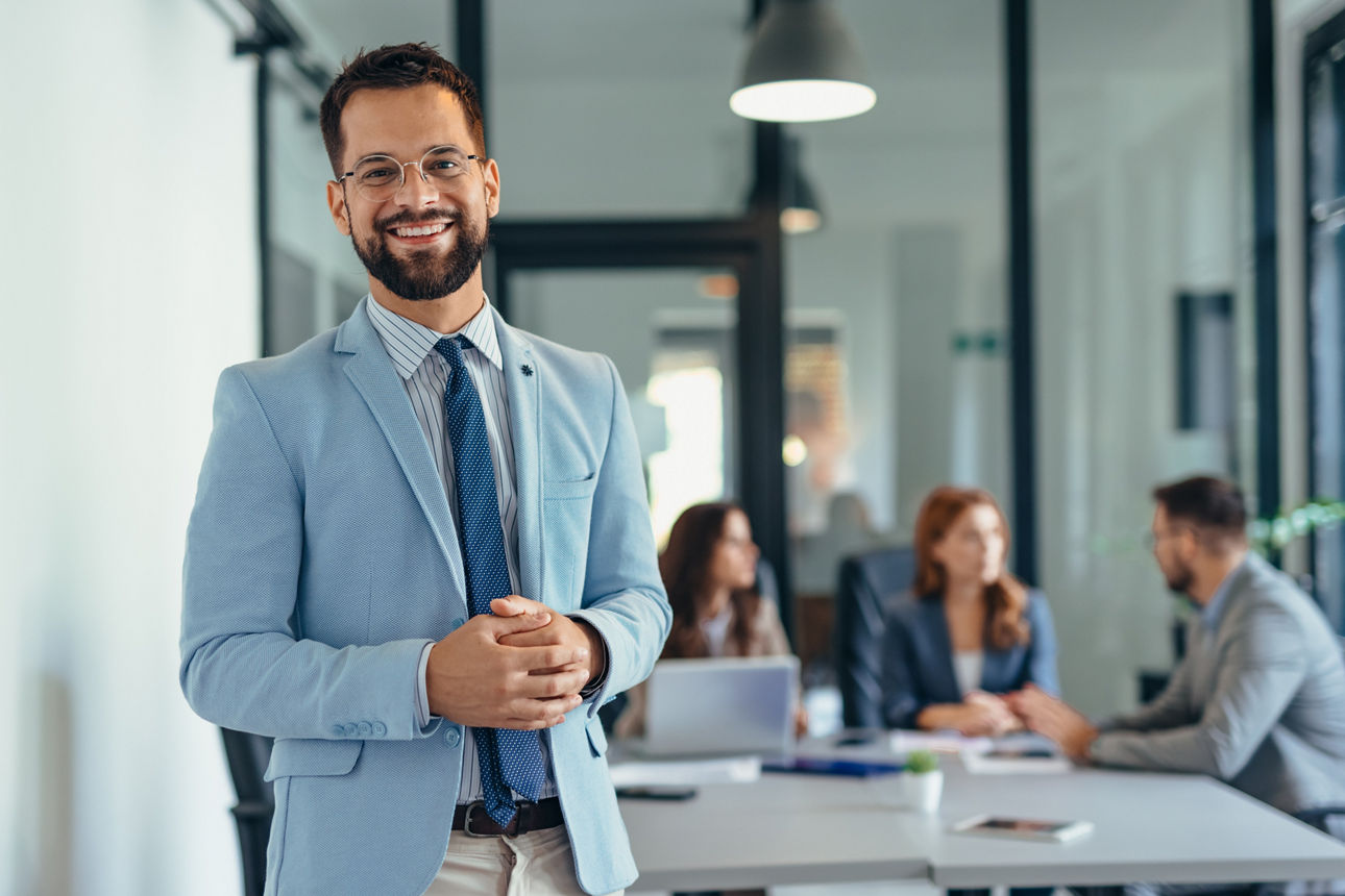 Lächelnder Bankberater steht im Büro