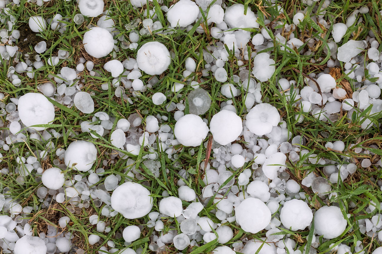 Large hail covering the ground after a severe thunderstorm in Kansas.