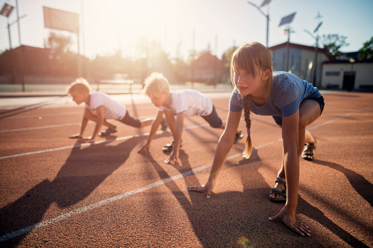 Kids preparing for track run race start. Kids are waiting for the signal for the race to begin. Hot and sunny summer day. - Getty 904094442