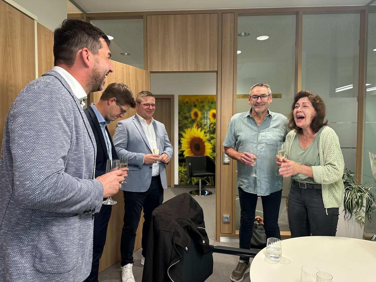 Mitarbeiter der Bank und die Kundin lachen vor Freude