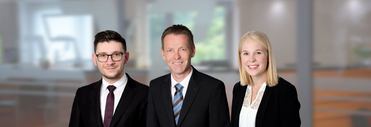 Drei Mitarbeiter der Volksbank Immobilien GmbH