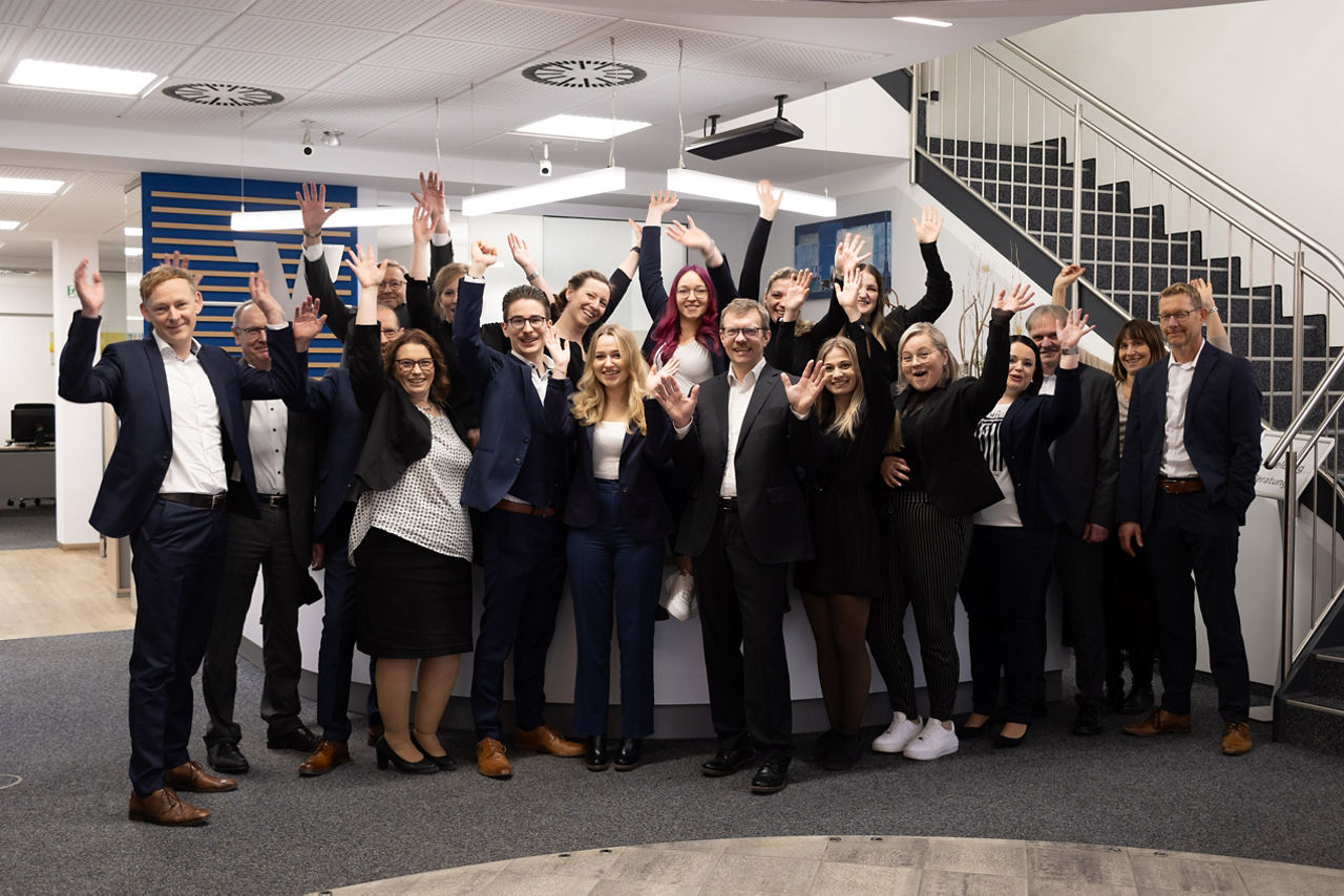 Gruppenbild Mitarbeiter - Hände oben