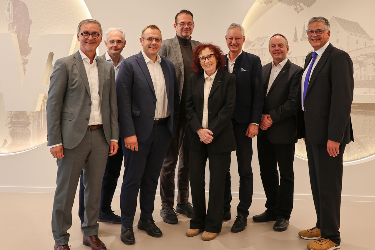 Eine Gruppe von Personen steht in der wiedereröffneten Hauptgeschäftsstelle