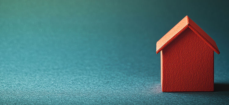 Haus-Grafik in rot vor blau-türkisem Hintergrund