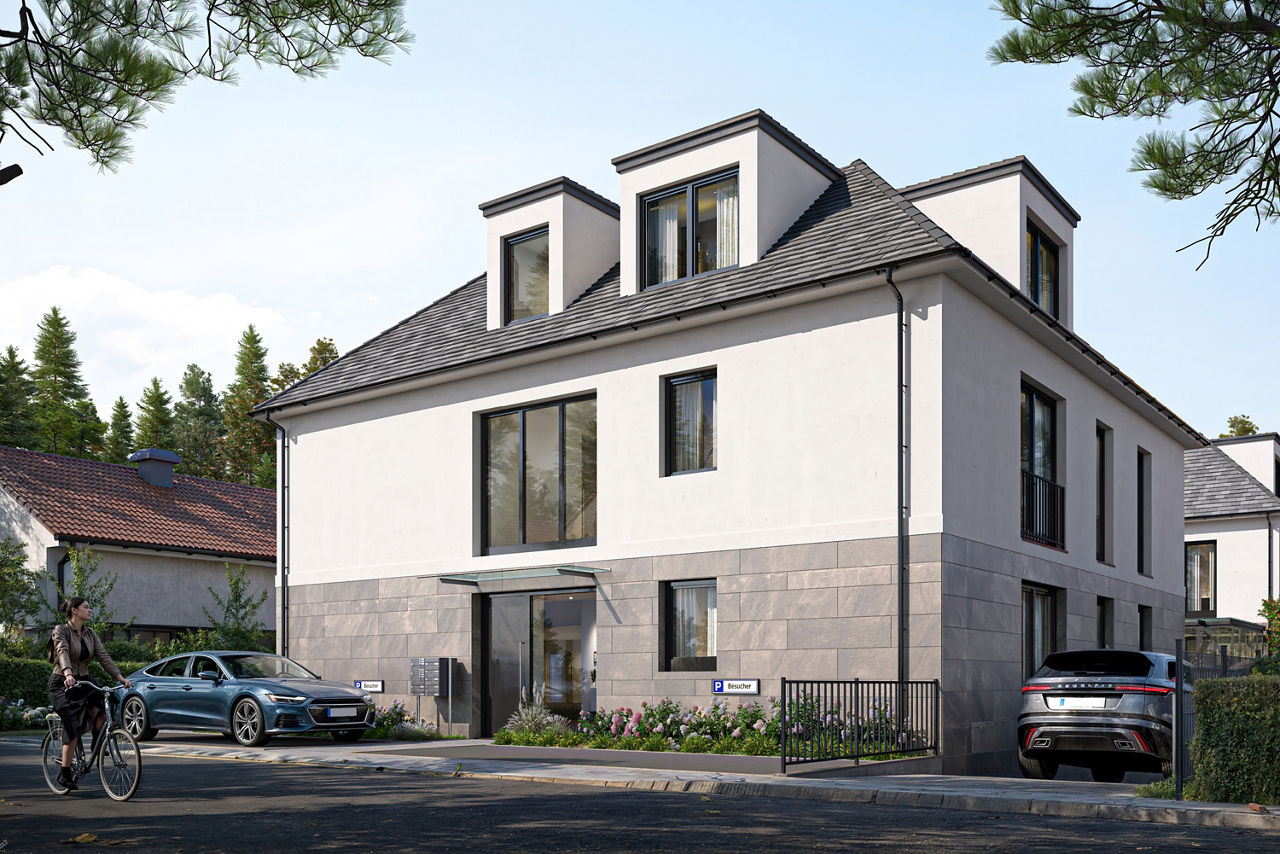 Ein dreistöckiges Gebäude, wahrscheinlich ein Wohnkomplex, mit einem hellbeigen/cremefarbenen Äußeren