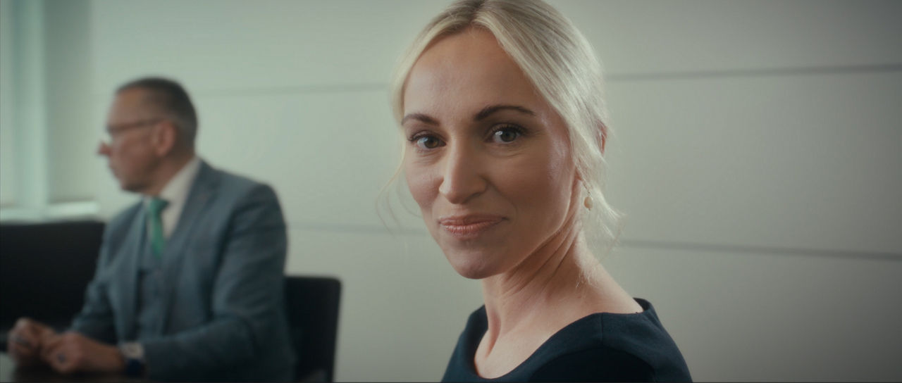 Blonde Frau schaut in die Kamera