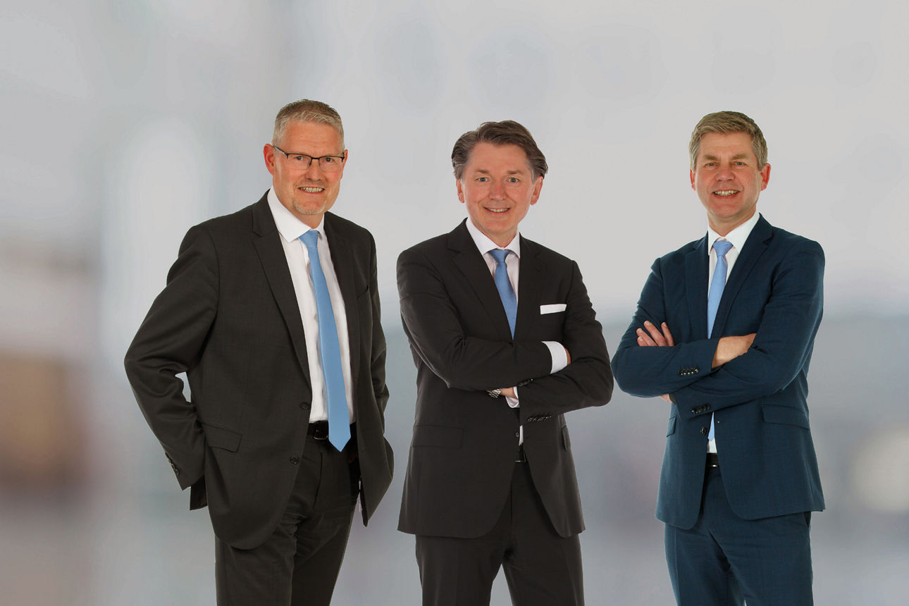Vorstände der Bank vor einem Sonnenuntergang