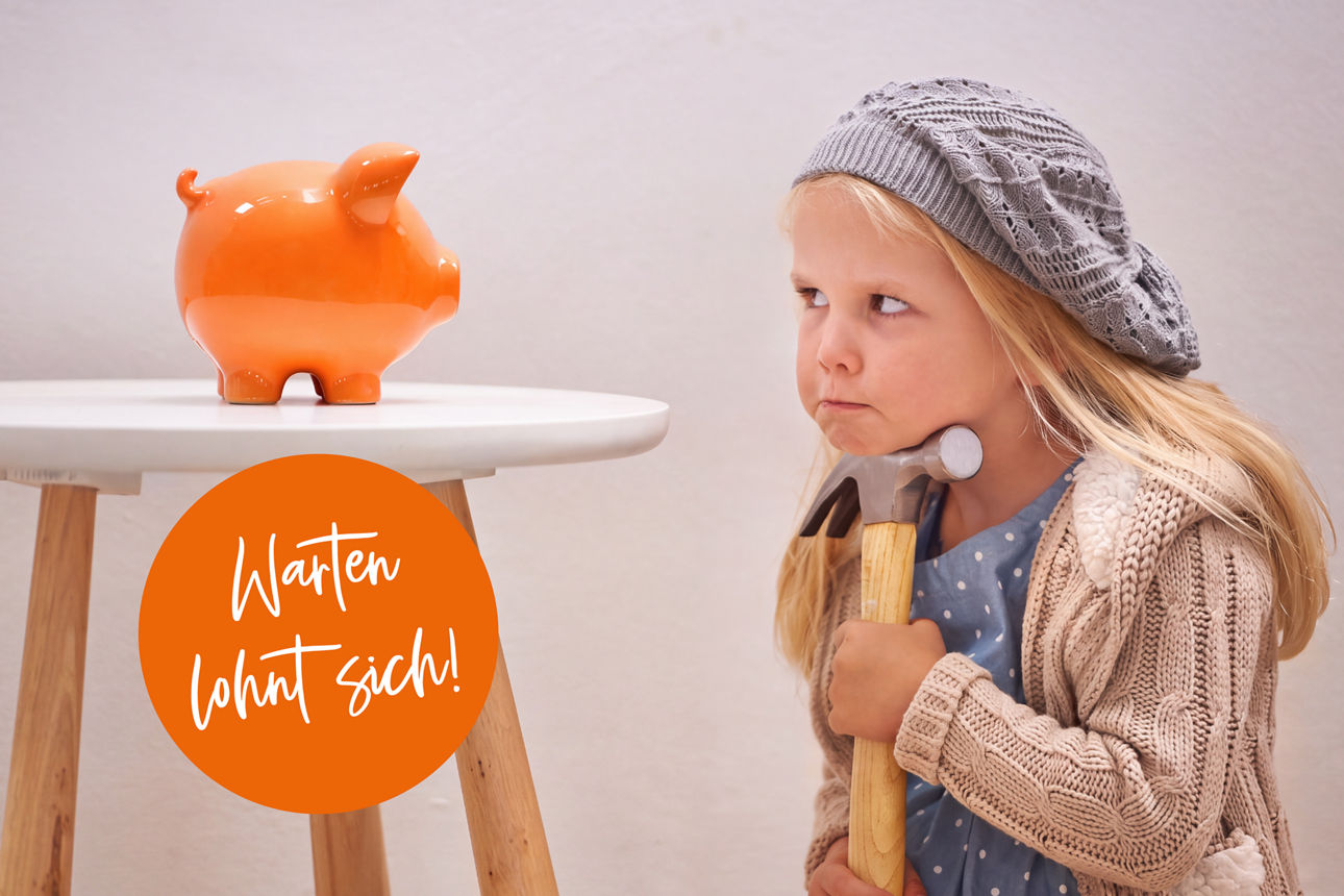Little girl saving her money in to porcelain pig.