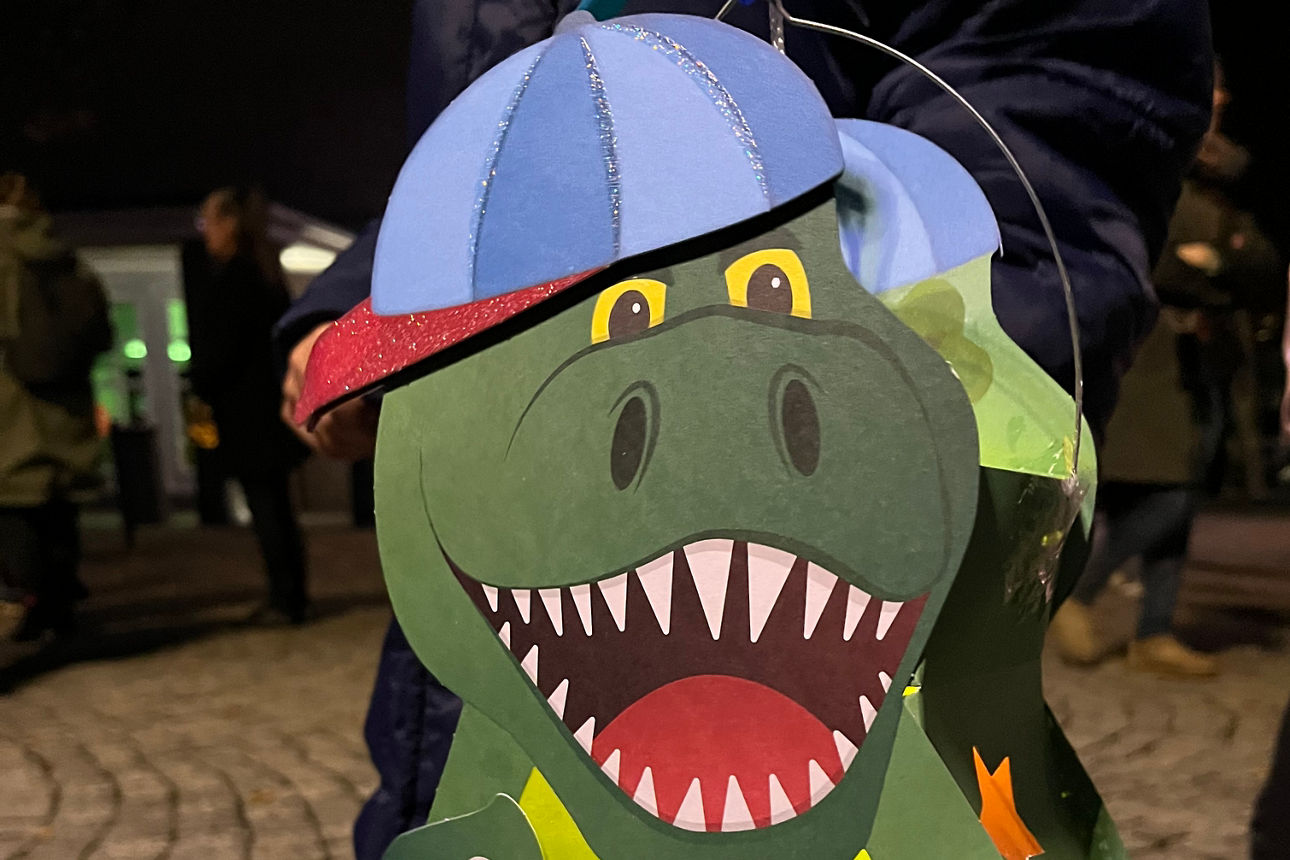 Kleiner Junge hält eine Dino-Laterne