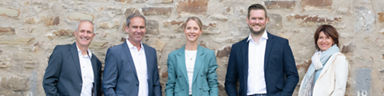 Unsere Immobilienberater vor einer Hauswand