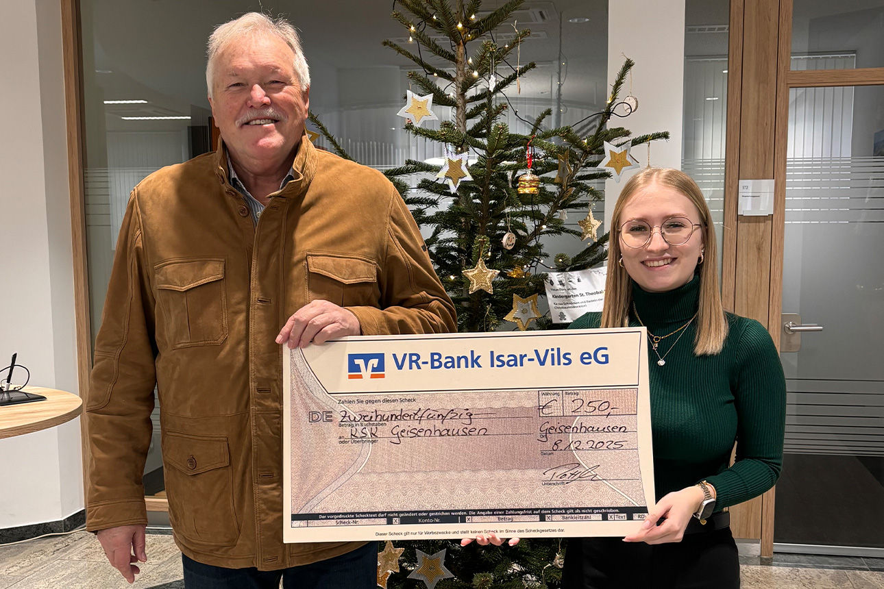 Ein Mann und eine Frau lächeln in die Kamera. Sie halten einen Riesenspendenscheck in der Hand.