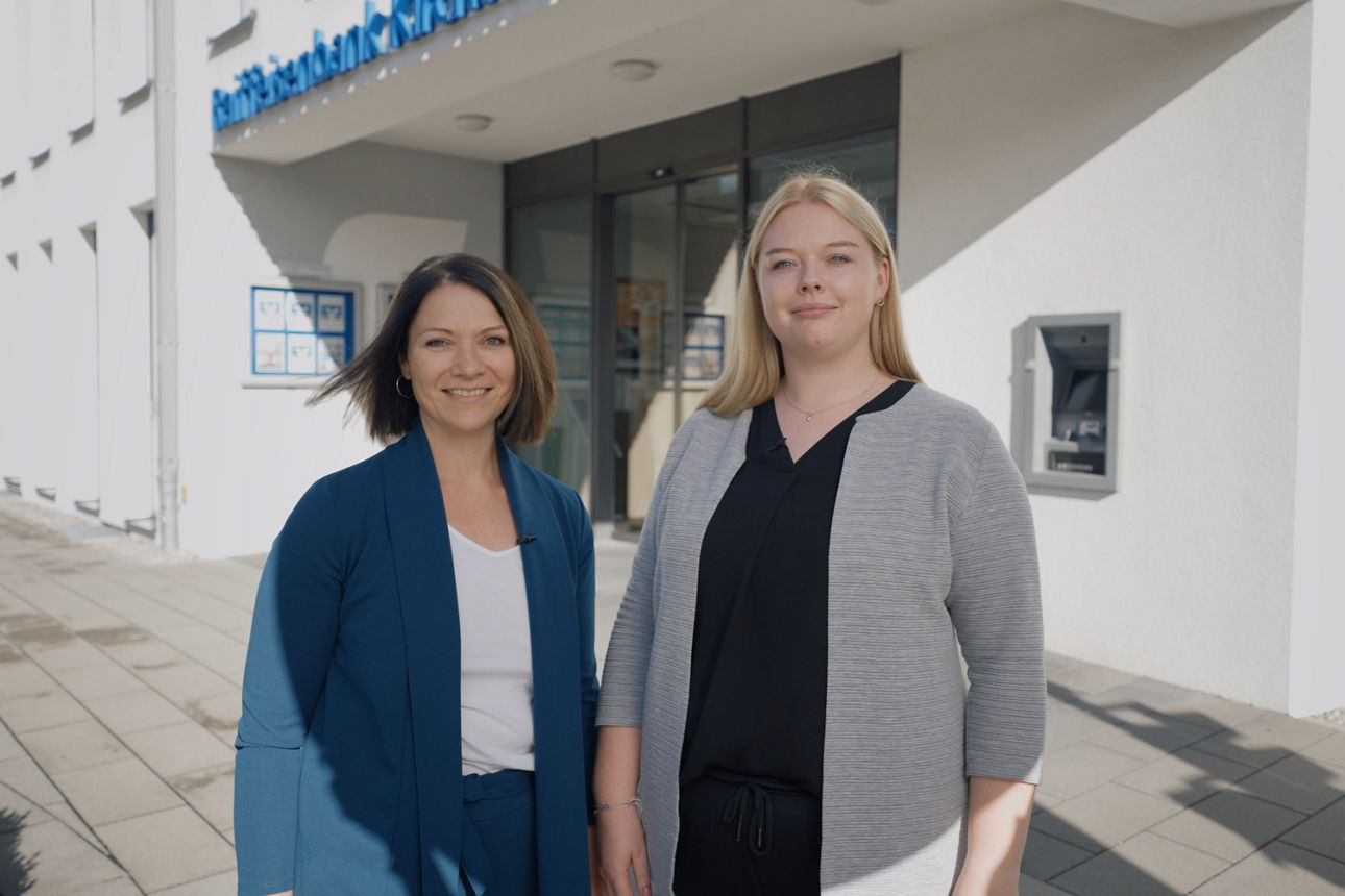 Zwei Frauen stehen vor einem Gebäude