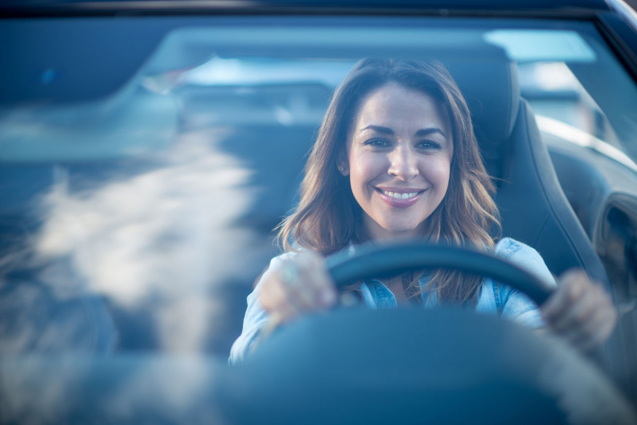 Glückliche Frau am Steuer eines Autos