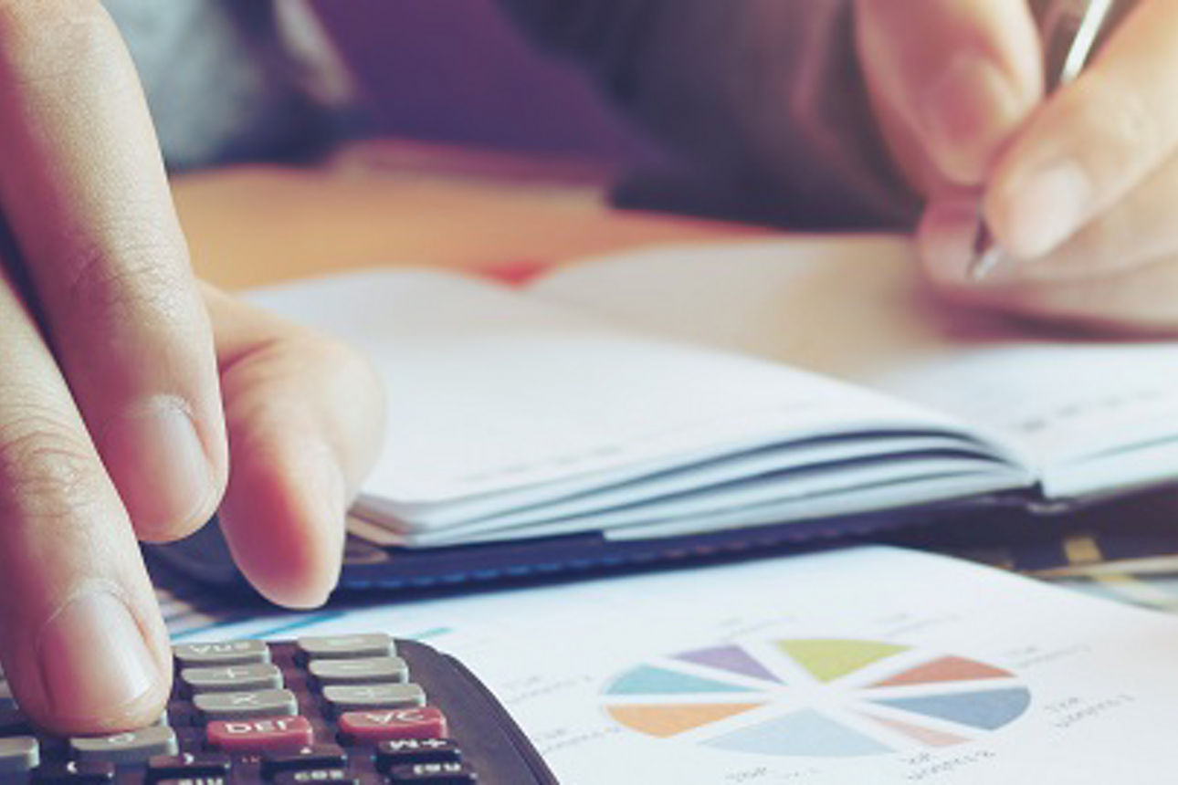Close up hand man doing finance and calculate on desk about cost at home office.