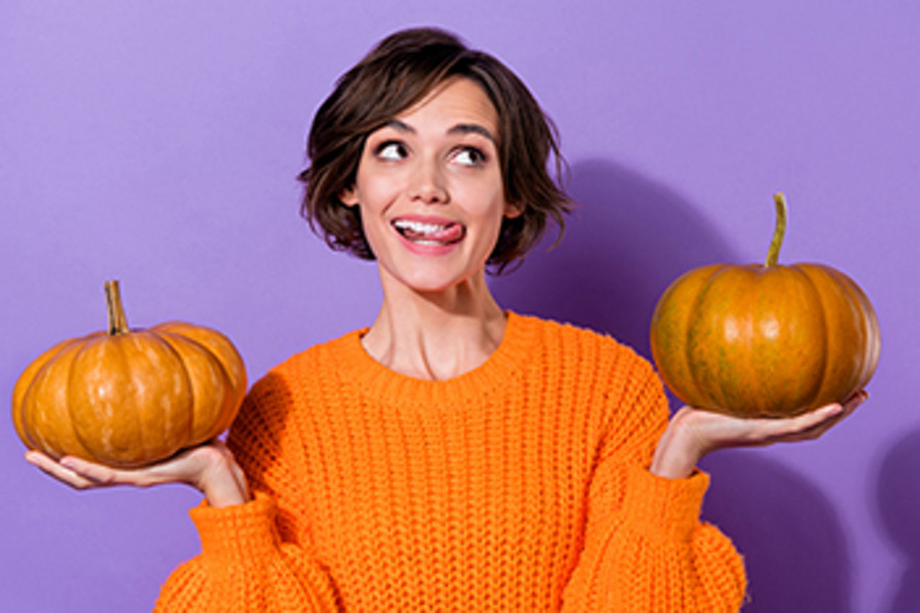 Frau hält zwei Kürbisse in ihren Händen