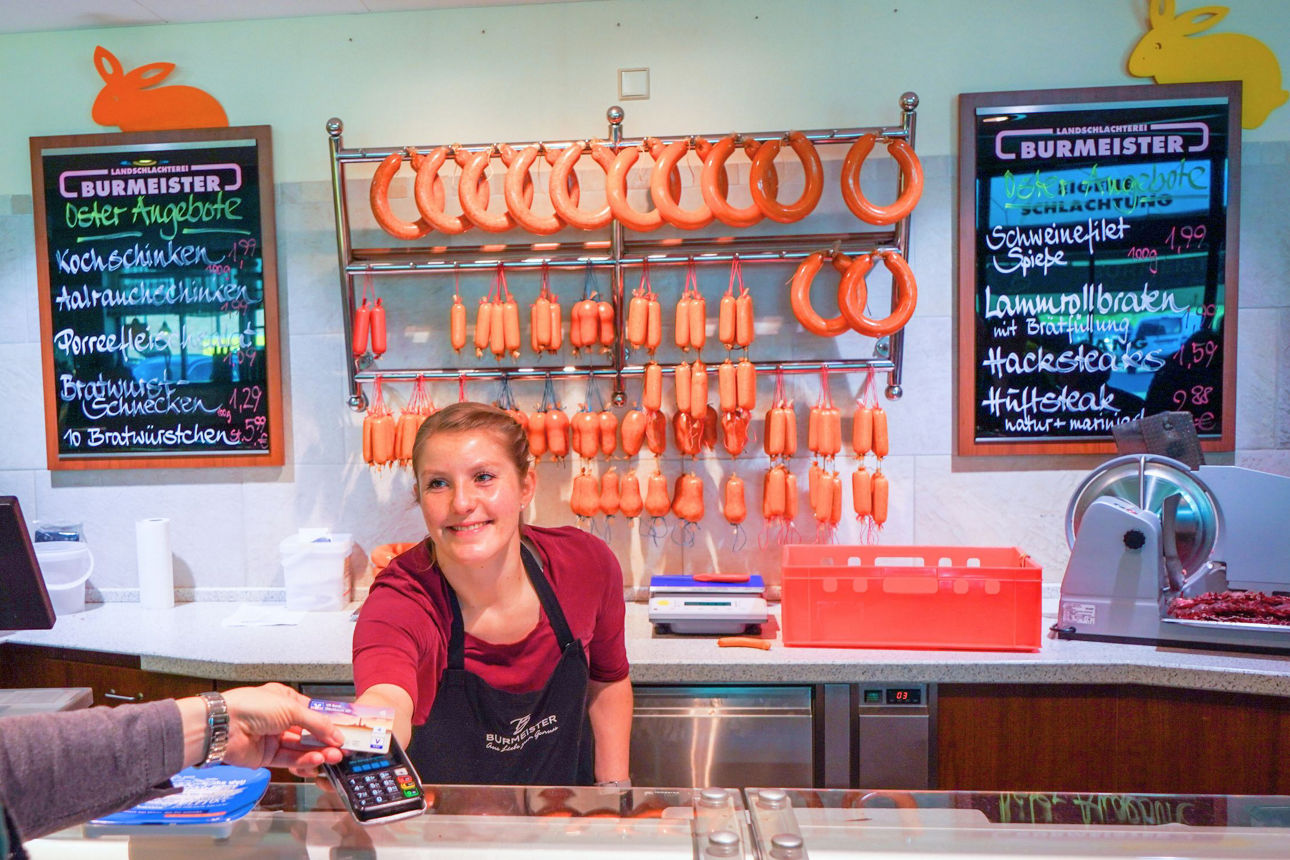 Zwei Männer stehen in einer Werkstatt vor einem Laptop