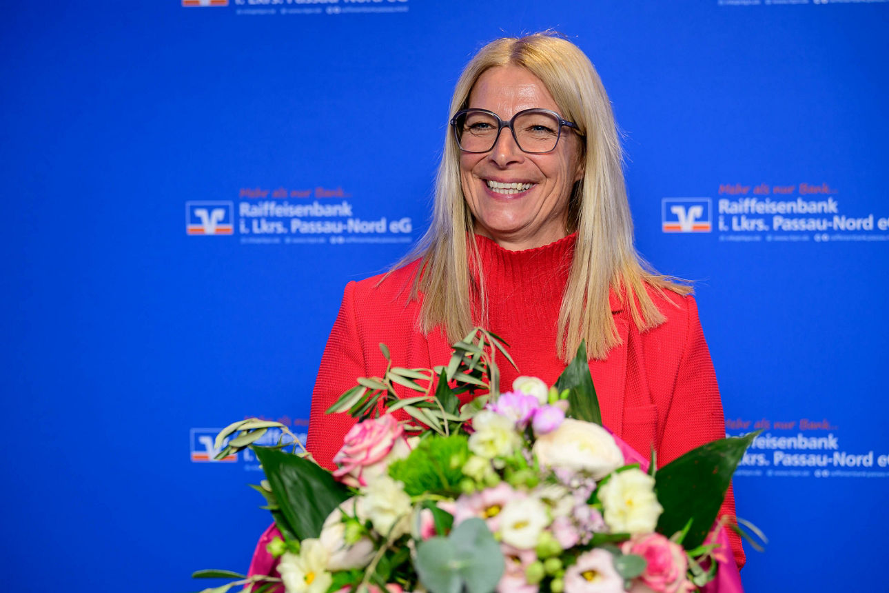 Nahaufnahme einer Frau mit einem Blumenstrauß.