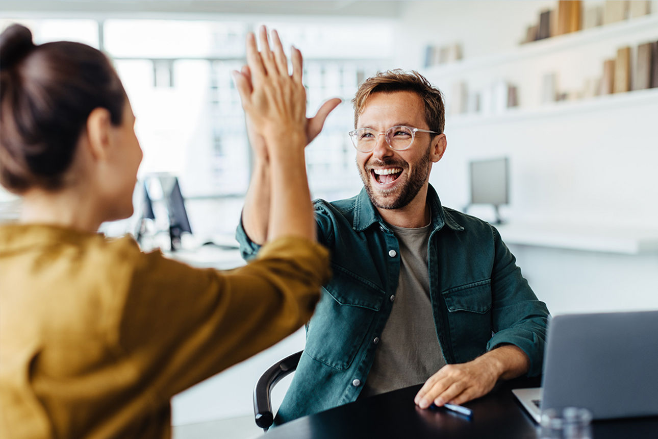 Zwei Personen geben sich ein High-Five