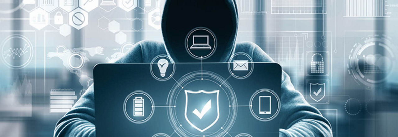 Eine Person in einem Kapuzenpullover sitzt vor einem Laptop. Um sie herum sind Symbole für Sicherheit, Geräte und Kommunikation angeordnet.
