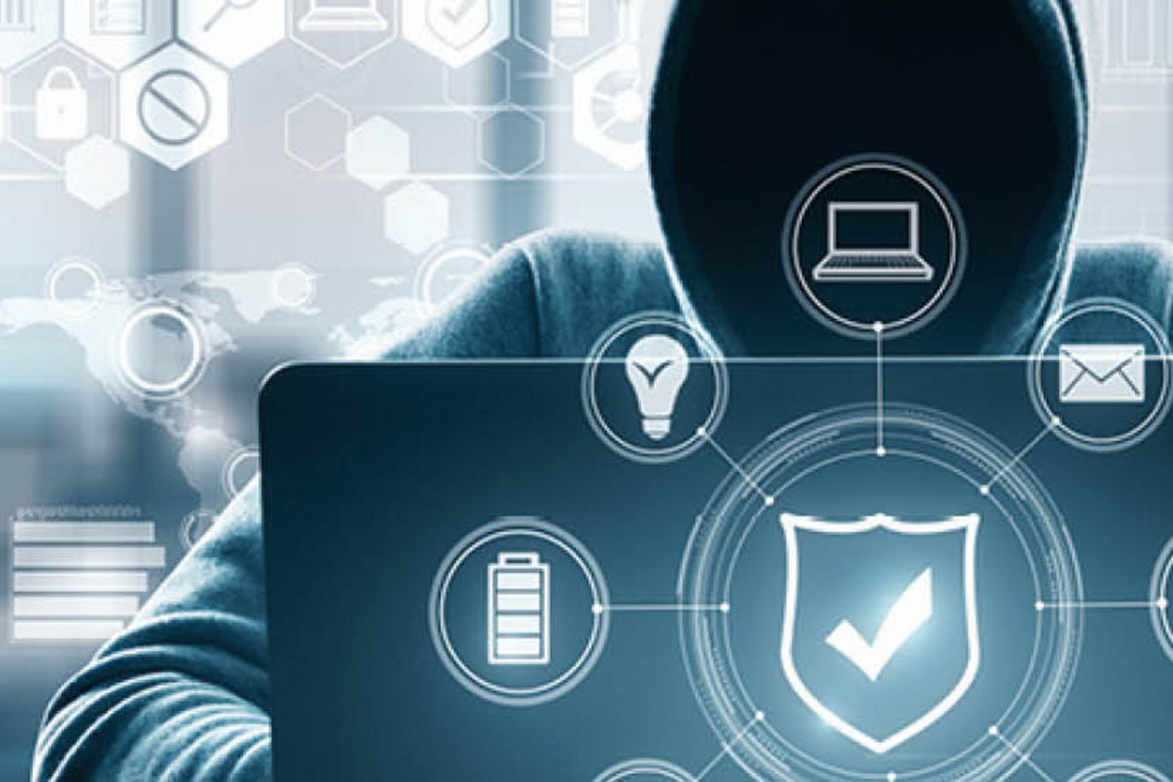Eine Person in einem Kapuzenpullover sitzt vor einem Laptop. Um sie herum sind Symbole für Sicherheit, Geräte und Kommunikation angeordnet.