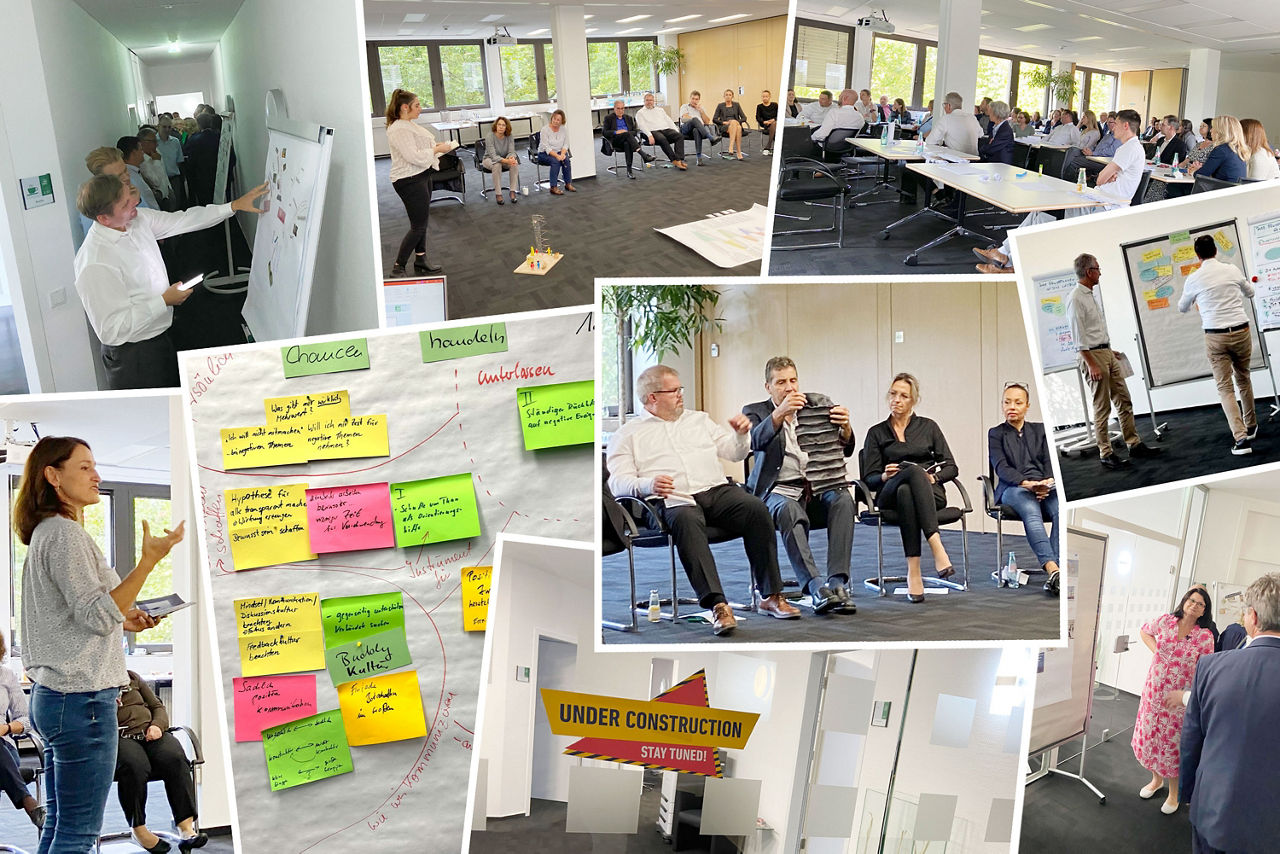 Menschen erarbeiten in einem Workshop an Metaplanwänden das Leitbild der Bank