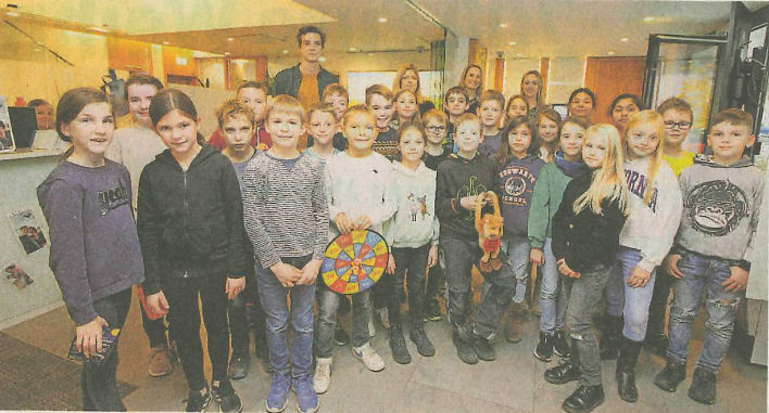 Eine Gruppe von Kindern, sowohl Jungen als auch Mädchen, steht in einer Reihe.