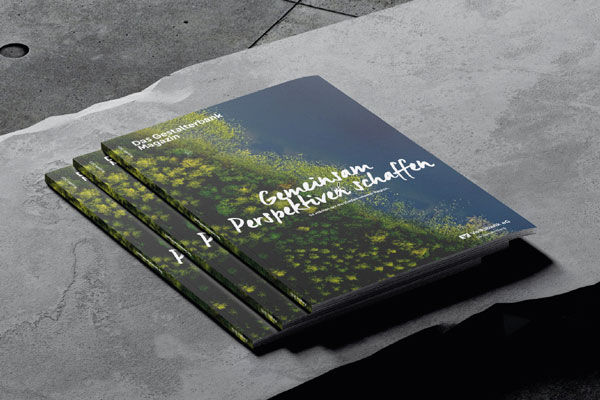 Mehrere GestalterbankMagazine trappiert auf einem Betonstein.