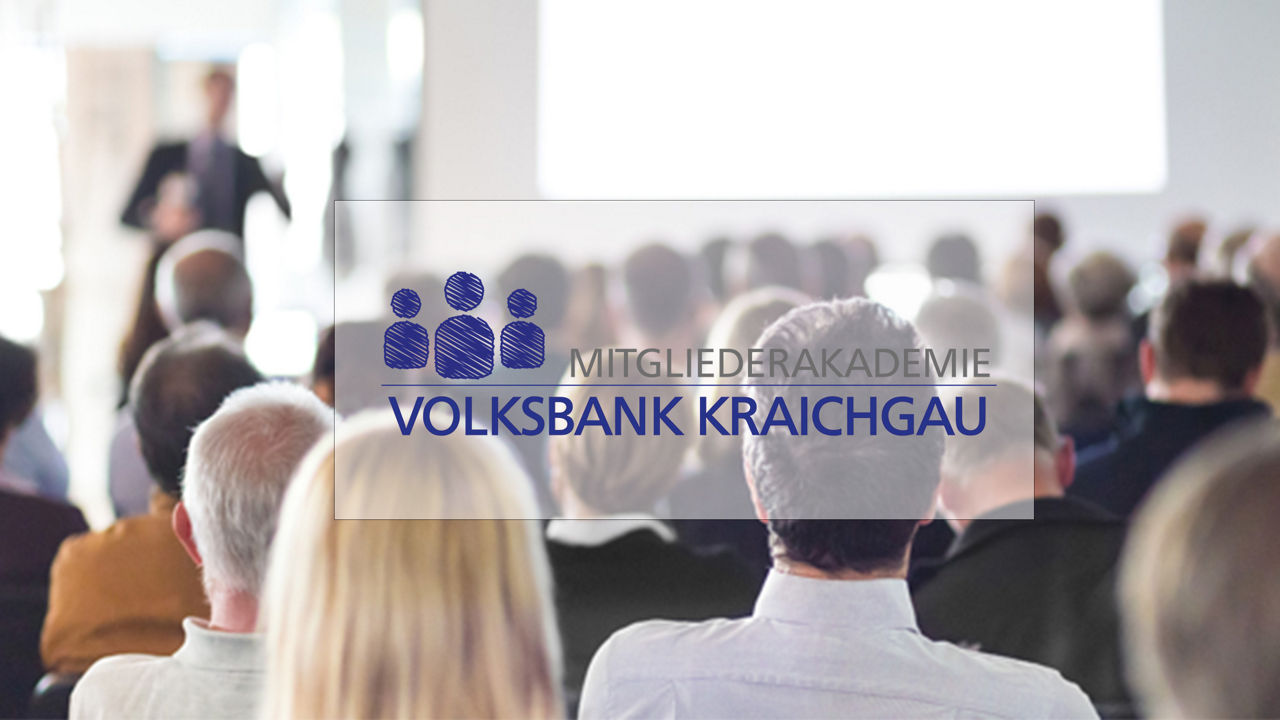 Menschen bei einem Vortrag mit Logo der Mitgliederakademie der Volksbank Kraichgau.