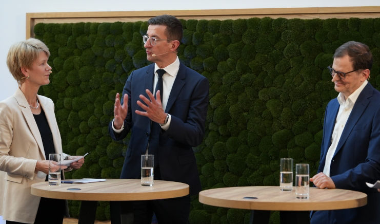 Zwei Männer und eine Frau sind in einem Interview