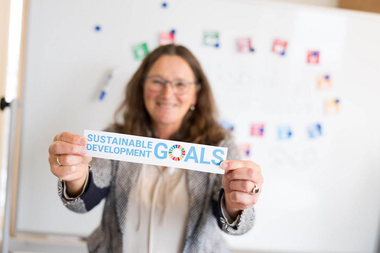 Nachhaltigkeitsmanagerin zeigt die Sustainable Development Goals. 