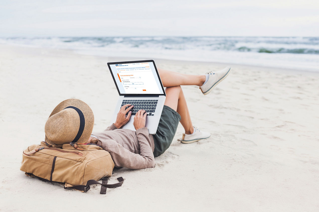 Resting woman using laptop on a beach