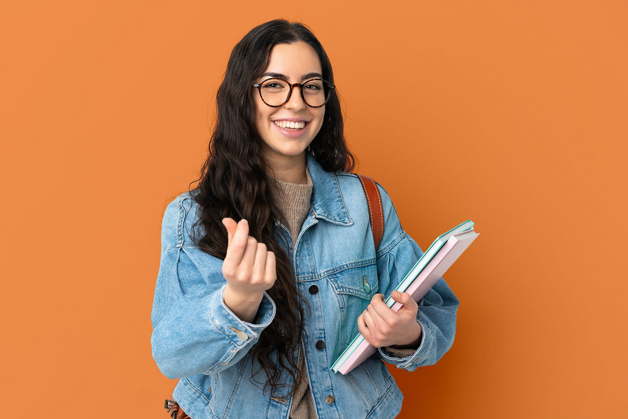 Young student woman isolated on white background making money gesture