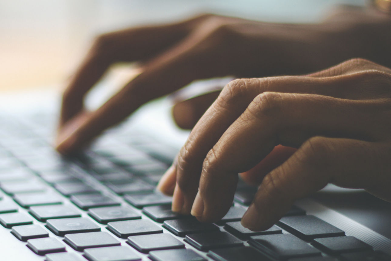 Finger tippen auf einer Laptoptastatur