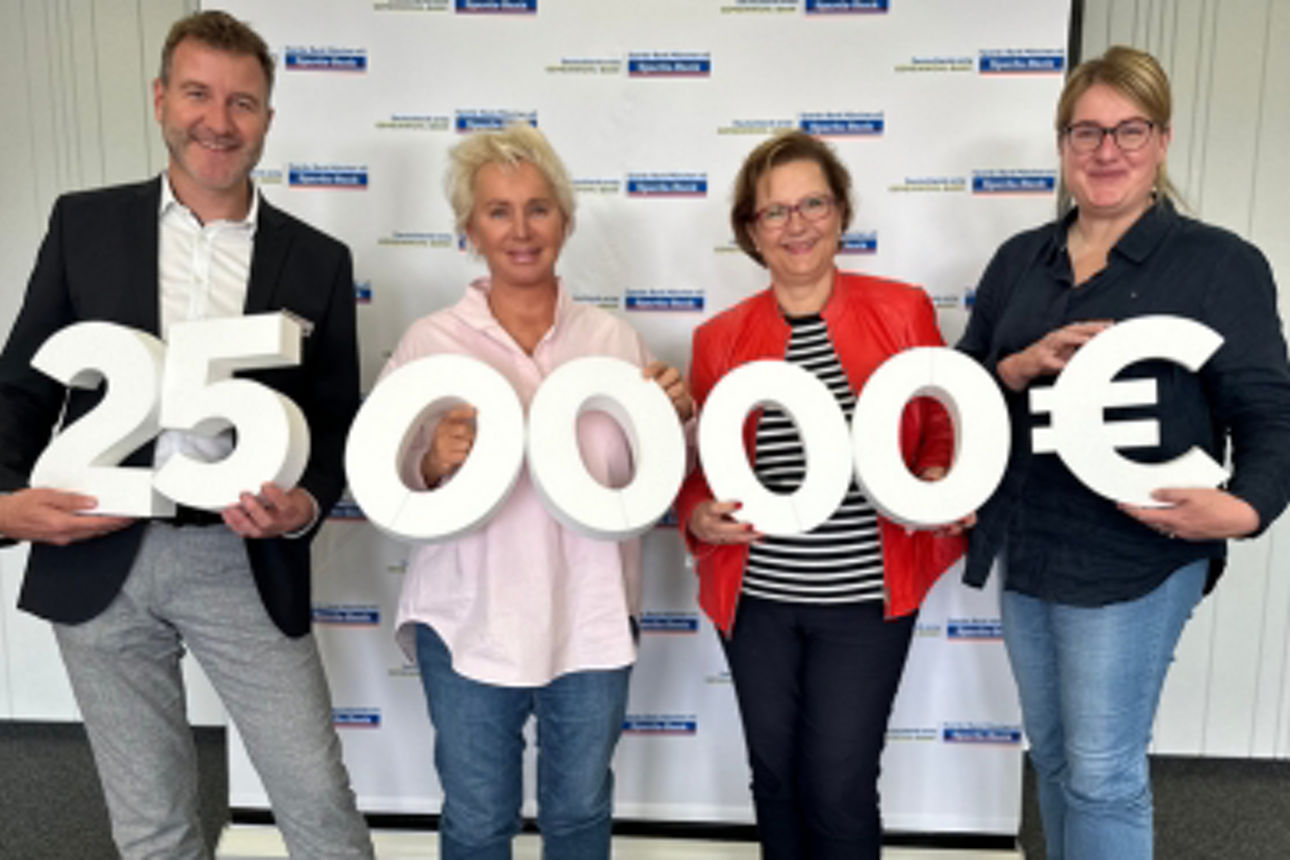 Gruppenbild von 2 Frauen mit einigen Kindern, die neue Schulranzen geschenkt bekommen