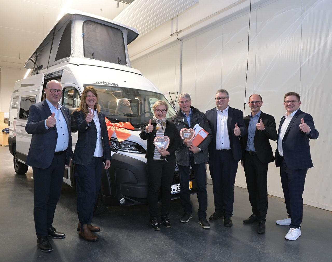 6 Personen bei der Übergabe des Wohnmobils