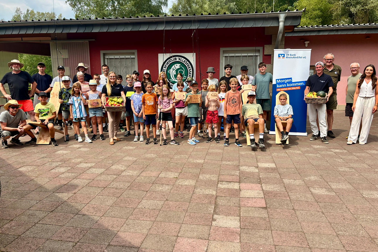 Kinder und Erwachsene mit Erntekisten vor Vereinsheim; Schild: VR Bank RheinAhrEifel eG