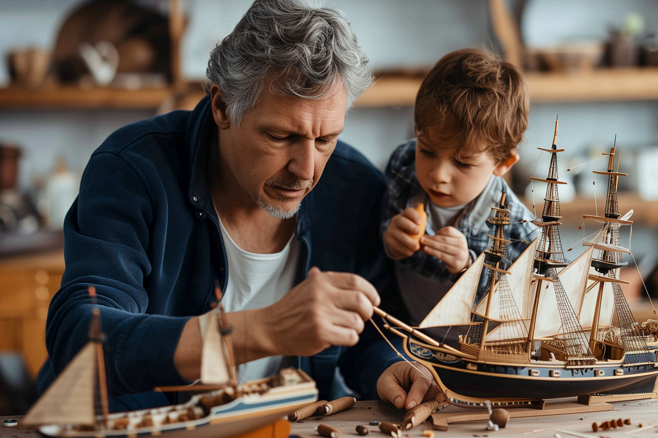 Vater und Sohn bauen ein Modellschiff Zuhause. 