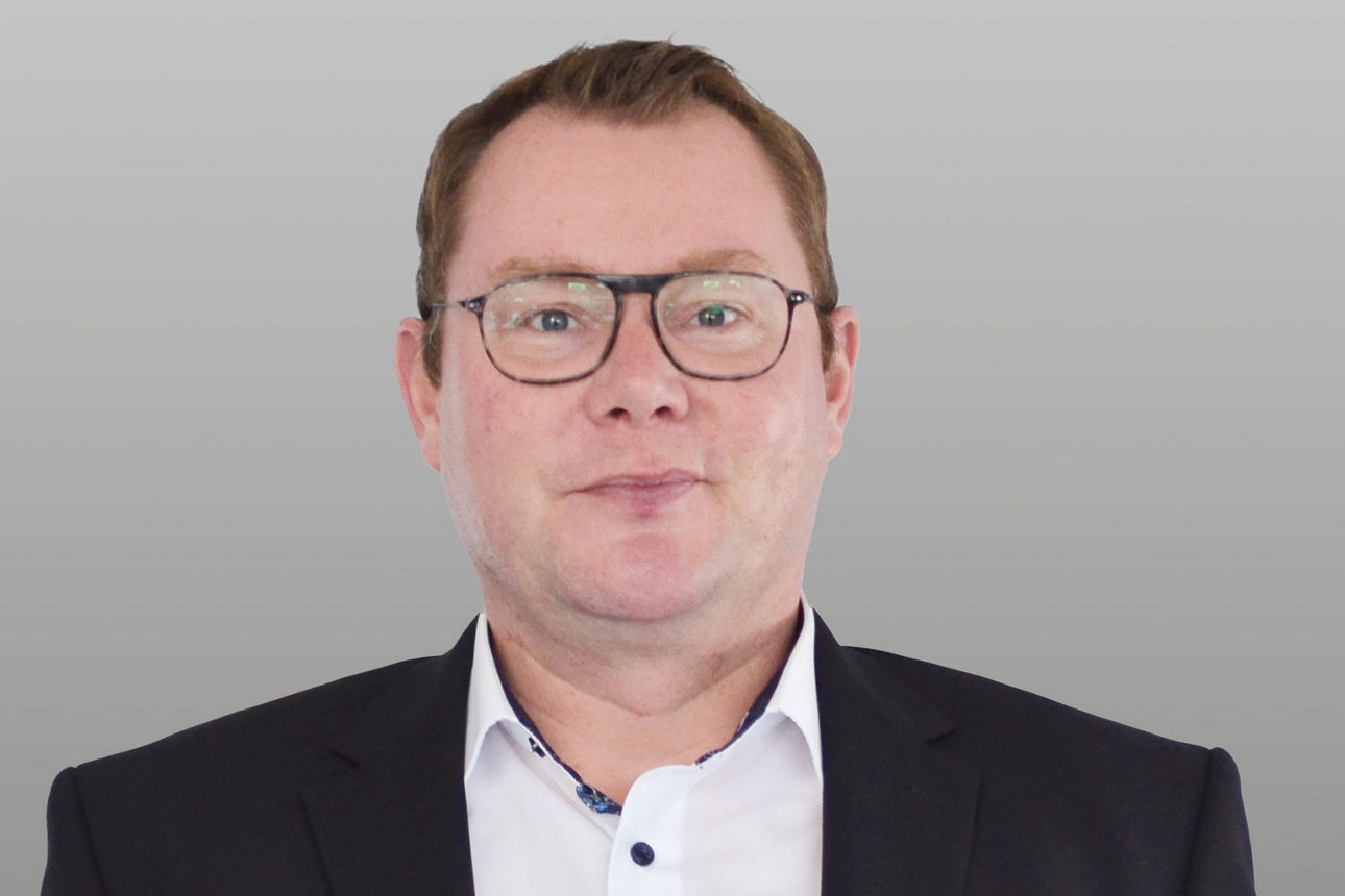 Geschäftskundenberater Stefan Röhrig vor grauem Hintergrund