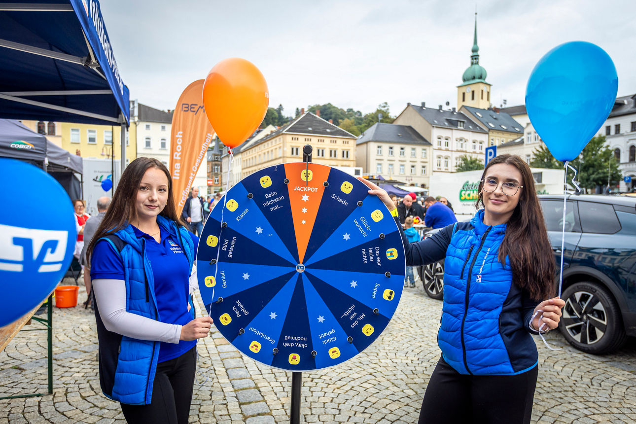 2 Mitarbeiterinnen der Volksbank Pirna vor Glückrad