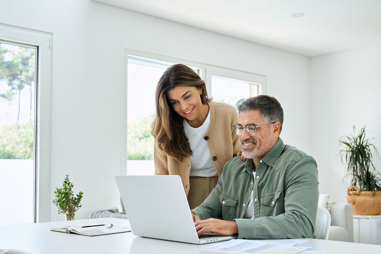 Ein Man und eine Frau schauen schauen auf ein Laptop