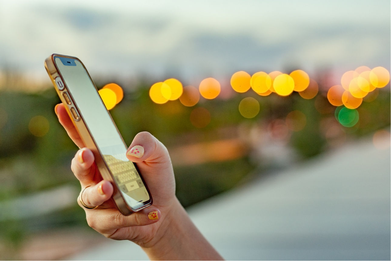  iPhone against urban lights at twilight