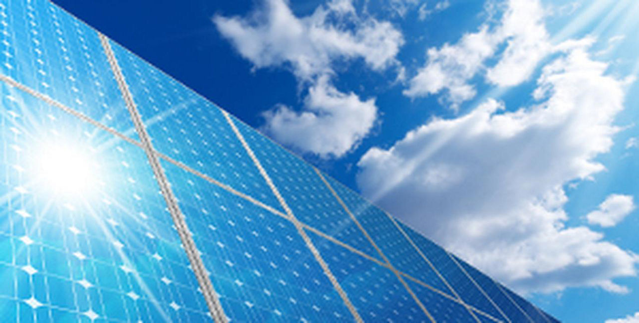 Bild einer Photovoltaikanlage, in der sich die Sonne spiegelt