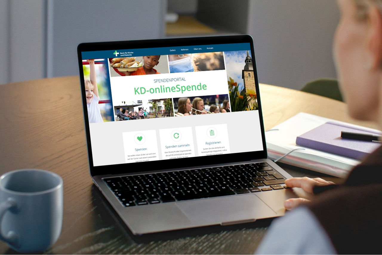 Eine Person arbeitet an einem Notebook, auf dem sie Startseite des Spendenportals geöffnet ist